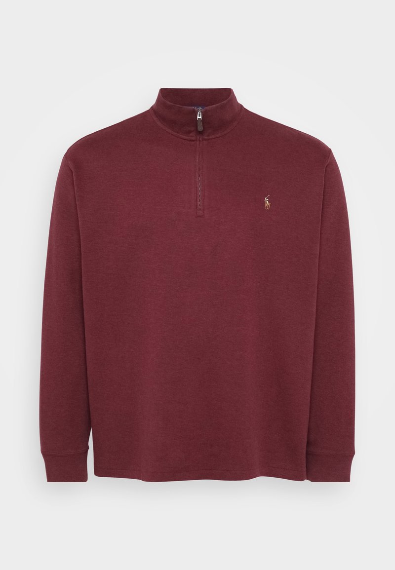 Burgundi pikendusega pullover, millel on veerandi tõmblukk kaeluses ja ribased varrukad. Selles on väike logo rinnal. Pehme, tekstureeritud materjal.