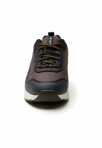 Pantofi sport maro închis și negri, cu un superior texturat, talpă groasă din cauciuc și accente portocalii pe șireturi. Prezintă o zonă a vârfului întărită.