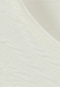 Tissu tricoté blanc doux avec un motif en côtes diagonales et de légers plis, mettant en valeur la texture et les détails du tissage.