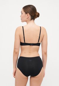 Black lingerie set comprising a sleek bralette with adjustable straps and high-waisted panties, made of soft, stretchy fabric.