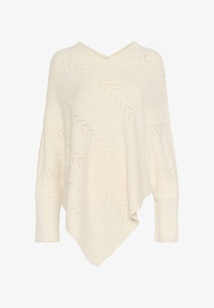Crème-kleurige gebreide poncho met een V-hals, voorzien van een chevronpatroon en ribbels in de mouwen. Zachte textuur en asymmetrische zoom.