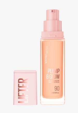 Gennemsigtig glassflaske med en lyserød pumpe, mærket "PLUMP & GLOW SPF 15 Foundation," 30 ml, ledsaget af en matchende lyserød hætte.