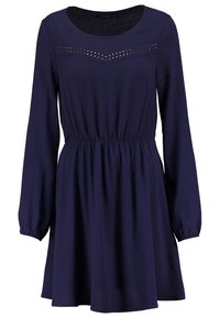 Robe bleu marine avec des manches longues, taille élastiquée et encolure arrondie. Présente un motif de clous métalliques sur le buste.