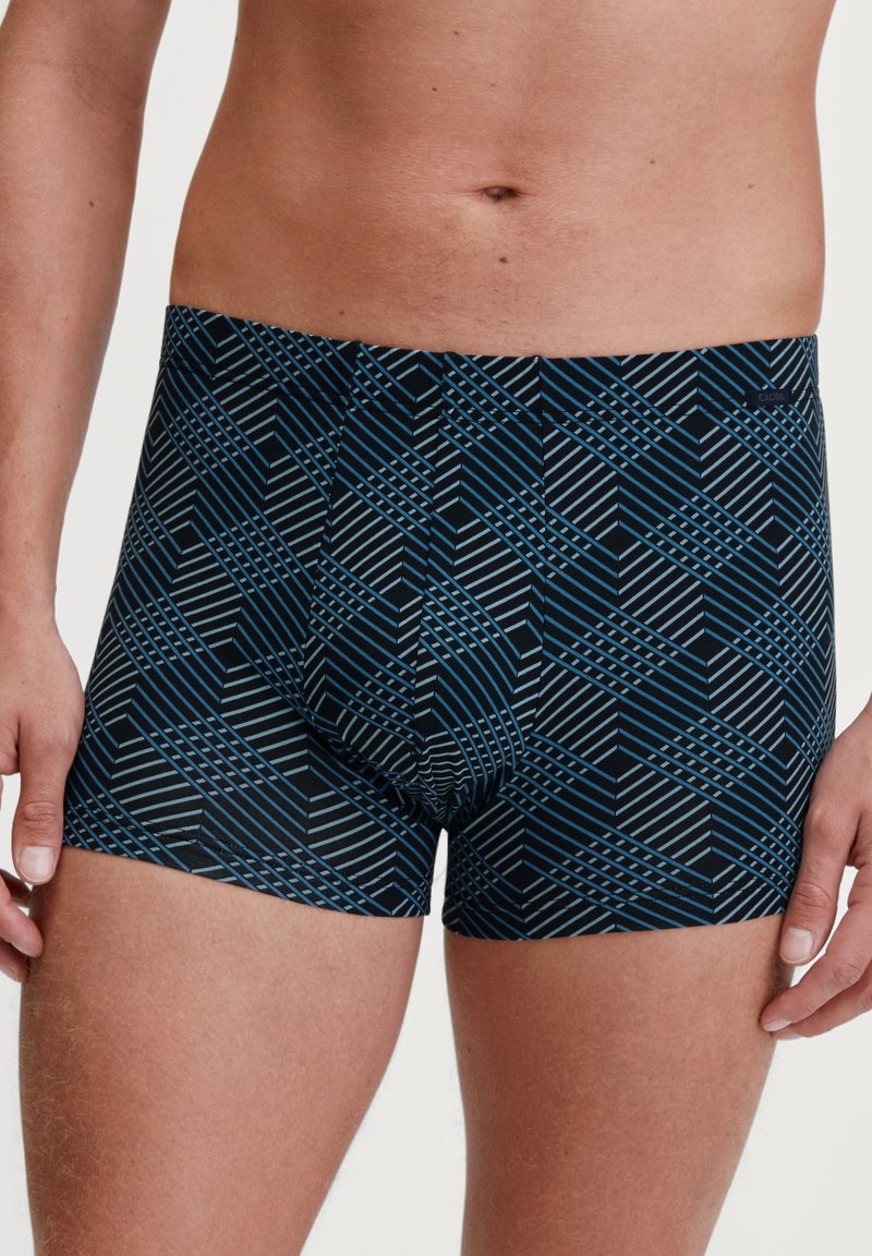 Boxer briefs in blue and black, featuring a geometric pattern of lines and shapes. Made of stretchy material with a fitted design.