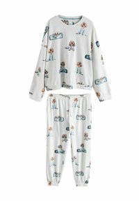Ljusgrå pyjamasset med långärmad topp och byxor med resår i midjan. Har upprepade illustrationer av hundar i blåa pyjamasar. Mjukt material.