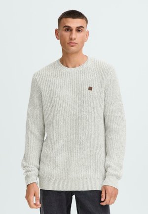 Light gray knit sweater with a textured pattern, round neckline, and long sleeves. Features a small brown label on the chest.