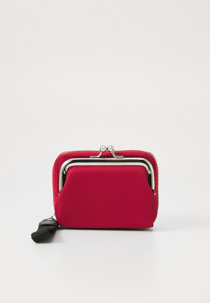 Red fabric wallet with a silver clasp, rectangular shape, zippered edge, and a detachable black strap for easy carrying.