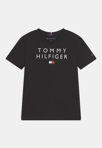 Black cotton t-shirt featuring the text "TOMMY HILFIGER" in white and a small logo in red, white, and blue on the chest. Short sleeves.