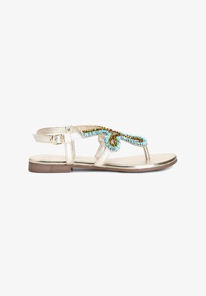 Gold metallic thong sandals featuring turquoise and brown beaded accents, adjustable strap, flat sole, and minimalistic design.