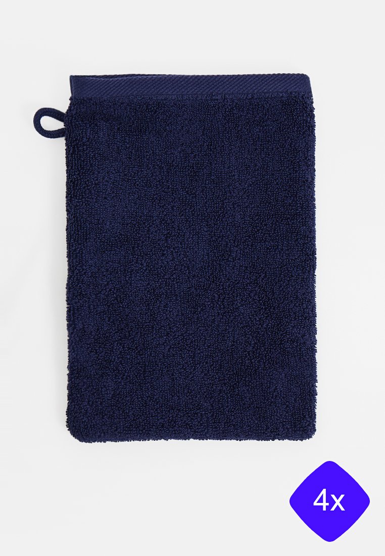 Serviette en éponge bleu marine avec une boucle de suspension en haut. Texture douce, forme rectangulaire et épaisseur importante pour l'absorption.