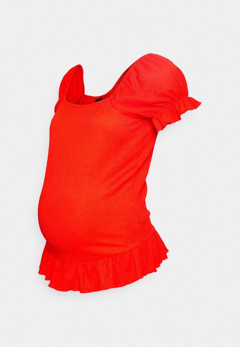 Blusa de maternidade vermelha texturizada com mangas curtas bufantes e bainha assentada. Possui um decote quadrado e tecido elástico para maior conforto.