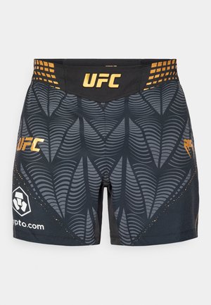 Fekete UFC rövidnadrág, texturált szürke levélmintával, arany díszítésekkel és logóval. Rugalmas derékrész a kényelem és a tökéletes illeszkedés érdekében.