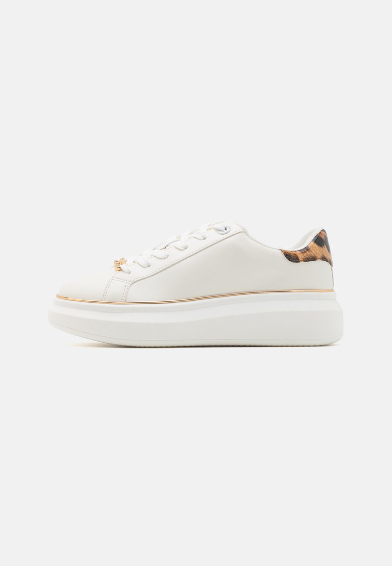 White leather sneaker with a thick platform sole, featuring a leopard print accent on the heel and metallic trim around the midsole.