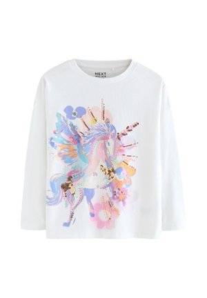 White long-sleeve shirt with a colorful winged unicorn design embellished with gold sequins and surrounded by pastel flowers.