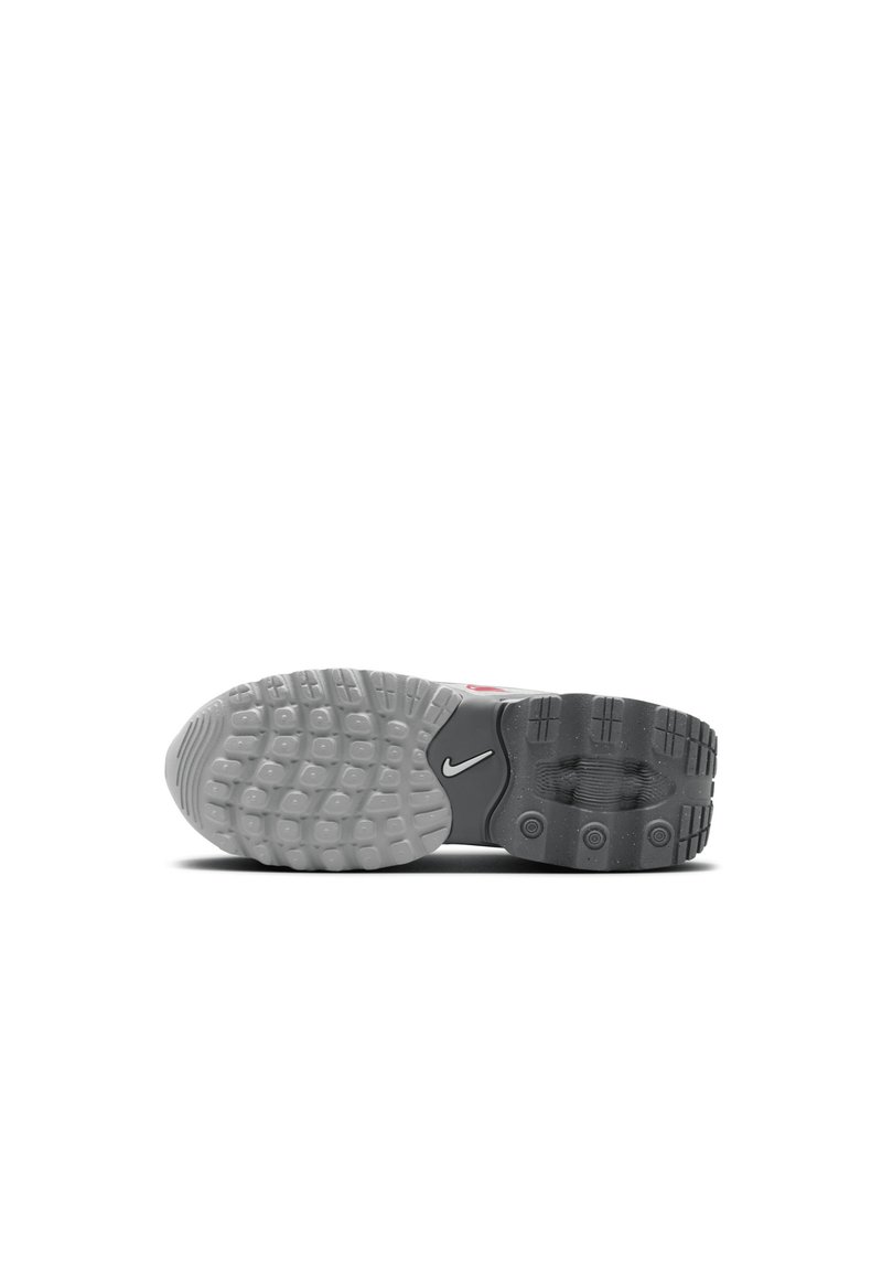 Semelle en caoutchouc gris et noir de sneaker Nike, présentant un motif texturé, des rainures pour l'adhérence et un accent logo blanc.