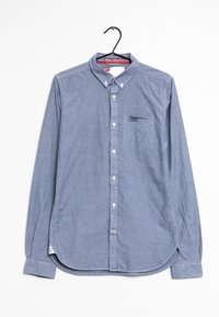 Vaaleansininen pitkähihainen nappikauluspaita, joka on valmistettu chambray-kankaasta. Paidassa on rintatasku ja pyöristetty helma, jossa on sivuhalkiot.