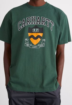 Zielona bawełniana koszulka z centralnym logo w formie tarczy w kolorze żółtym i czarnym oraz napisem "CARHARTT WIP THE LAZY DUCK."