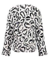 Blusa a maniche lunghe con macchie di leopardo astratte in bianco e nero su sfondo bianco, mostrata sul retro.