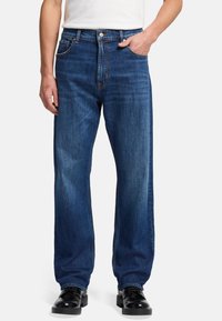Denim jeans in een donkerblauwe tint met een rechte pijp, voorzien van voorzakken, subtiele vervaging en een metalen knoopsluiting.