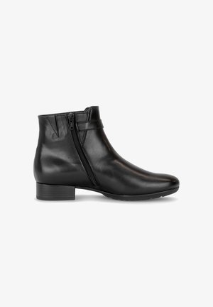 Bottine en cuir noir à talon bloc bas, fermeture éclair latérale et couture décorative, présentée de profil sur fond blanc.