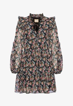 Kwiecista sukienka z przezroczystej czarnej tkaniny z różowymi i zielonymi wzorami. Posiada bufiaste rękawy, falbaniaste akcenty oraz wiązanie przy dekolcie.