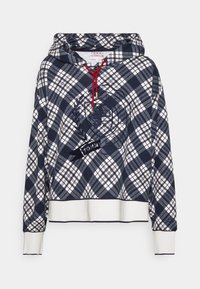 Felpa con cappuccio a quadri blu navy con motivi bianchi e dorati. Presenta un emblema rotondo con la scritta "TOMMY" e lacci rossi. Polsini e orlo a coste.