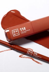 Longwear lipstick and automatic lip pencil in a warm reddish-brown shade, featuring sleek packaging with white text and matching product swatch.