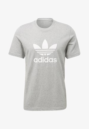 Šedé bavlněné tričko s kulatým výstřihem. Obsahuje velké bílé logo Adidas a tři horizontální pruhy pod logem. Krátké rukávy.