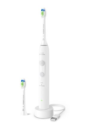 Philips Sonicare elektrische tandenborstel met vervangbare borstelkop, oplaadbasis en USB-kabel op een witte achtergrond.