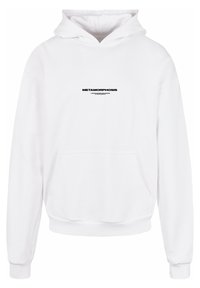 Hvid hættebluse med en frontlomme, ribbede manchetter og sort tekst "METAMORPHOSIS" på brystet. Blødt stof.