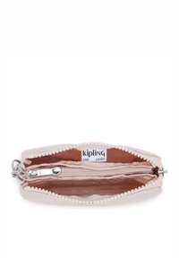 Kipling wallet in light pink fabric, featuring a zippered closure, interior compartments, and a label reading "live light." Textured detailing.