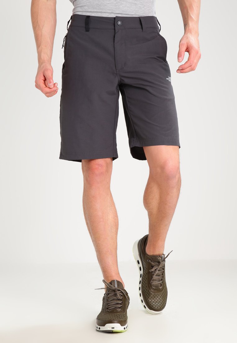 Dark gray shorts made of lightweight fabric, featuring a straight cut, flat front, and pockets. Paired with olive green, perforated shoes.