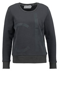 Mörkgrå sweatshirt med en stor glänsande CK-logotyp, rund hals, och ribbade ärmslut och nederkant, tillverkad av mjukt bomullsmaterial.