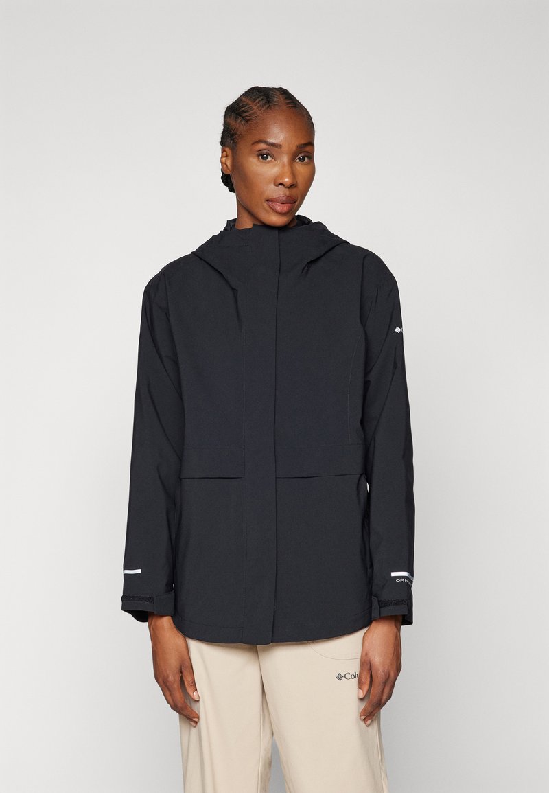 Veste imperméable noire avec une fermeture éclair sur le devant, capuche ajustable, deux poches avant et accents réfléchissants sur les manches. Texture lisse.