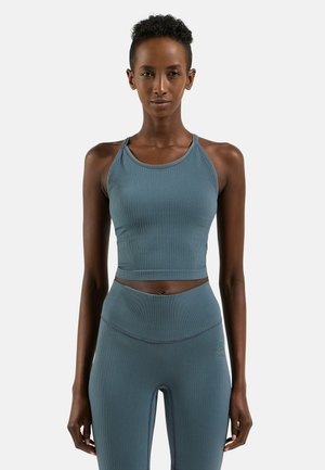 Ribbed, light blue sports crop top with thin straps, paired with matching high-waisted leggings featuring a subtle logo detail.