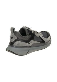 Gray athletic shoe with suede and mesh upper, black accents, padded collar, and a textured rubber sole. Reinforced heel for support.