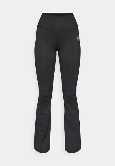 Black flared leggings made from smooth, stretchy fabric. High-waisted design with subtle logo detailing on the left thigh.