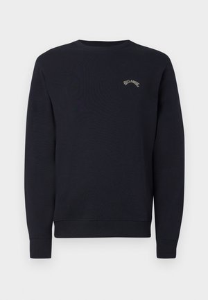 Navy blue sweatshirt with a crew neckline, ribbed cuffs, and waistband. Features a small, light-colored logo on the chest. Soft fabric texture.