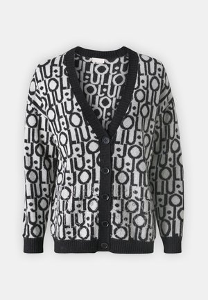 Cardigan bianco e nero con un motivo geometrico di cerchi e linee, scollo a V, polsini a coste e sei bottoni frontali.