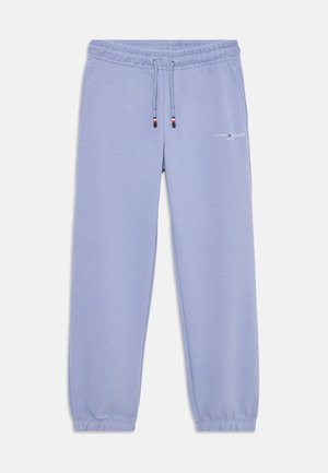 Pantalon de survêtement violet clair avec poignets et taille élastiques, cordon ajustable, et petit logo Tommy Hilfiger sur la cuisse gauche supérieure.