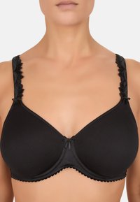 Zwarte beha met gladde cups, schulp-lace schouderbanden, en een klein strikje in het midden. Heeft een naadloos ontwerp en verstelbare bandjes.