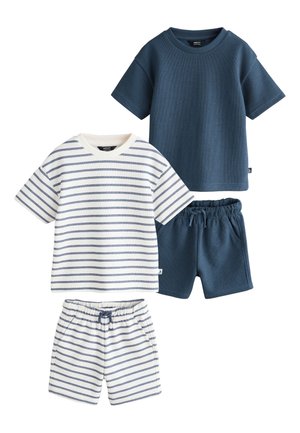 Zwei Sets legere Sommerkleidung für Kinder, jeweils mit einem kurzärmeligen T-Shirt und passenden Shorts; ein Set in Marineblau, das andere weiß mit marineblauen Streifen.
