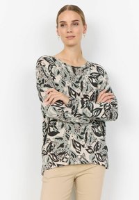 Pull à manches longues avec un motif floral en noir, turquoise et crème, avec une coupe décontractée et un col rond. Tissu texturé.