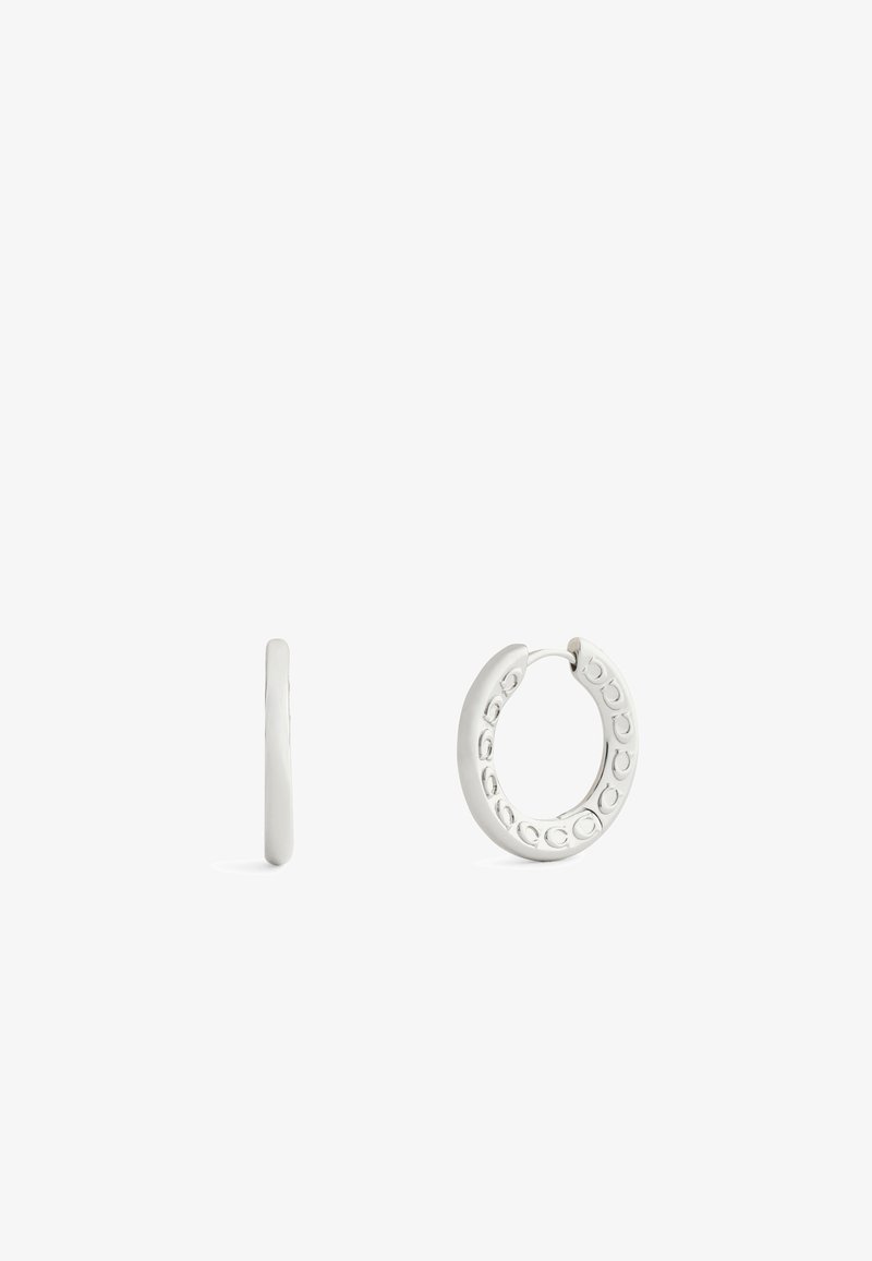 Silver hoop earrings with a textured pattern along one side, featuring a secure clasp and a smooth finish on the front.
