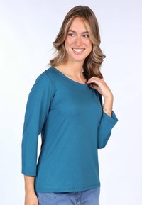 Türkisfarbenes Langarmoberteil mit weitem Halsausschnitt und lockerer Passform, aus weichem Stoff, mit umgeschlagenen Manschetten und glatter Textur.