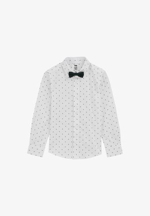 Camisa blanca de manga larga con botones, con pequeños estampados negros de árboles y una pajarita negra pegada al cuello.