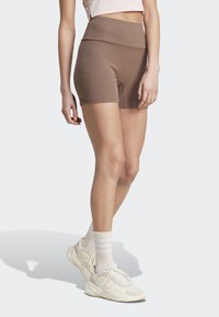 adidas Sportswear LOUNGE RIBBED HIGH-WAIST BIKE - Tights - earth strata