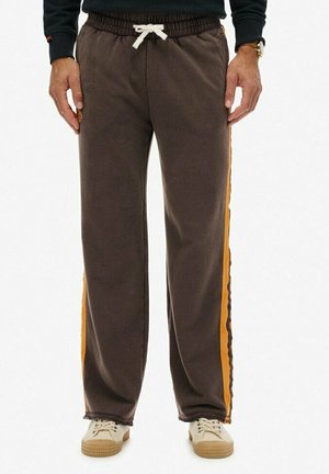 Brown sweatpants with an elastic waistband, white drawstring, and side stripes in bright orange. Crafted from soft, textured fabric.