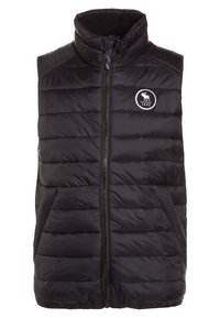 Czarna pikowana kamizelka z wysokim kołnierzem, zapinana na zamek błyskawiczny z przodu, z pionowym wzorem pikowania. Posiada okrągłe logo z łosiem i rokiem 1892.