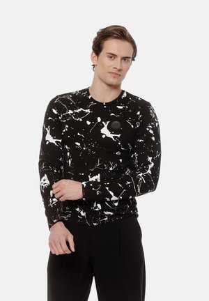 Czarna koszula z długim rękawem z białym wzorem plam, okrągły dekolt oraz okrągła naszywka logo z przodu. Miękka tkanina z dopasowanym krojem.